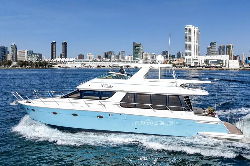 Slide: The Image of 2003 Carver 570 Voyager Pilothouse yacht cruising near city skyline. - 9