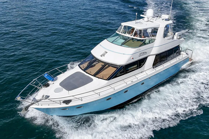 Slide: The Image of 2003 Carver 570 Voyager Pilothouse yacht cruising on open water. - 1