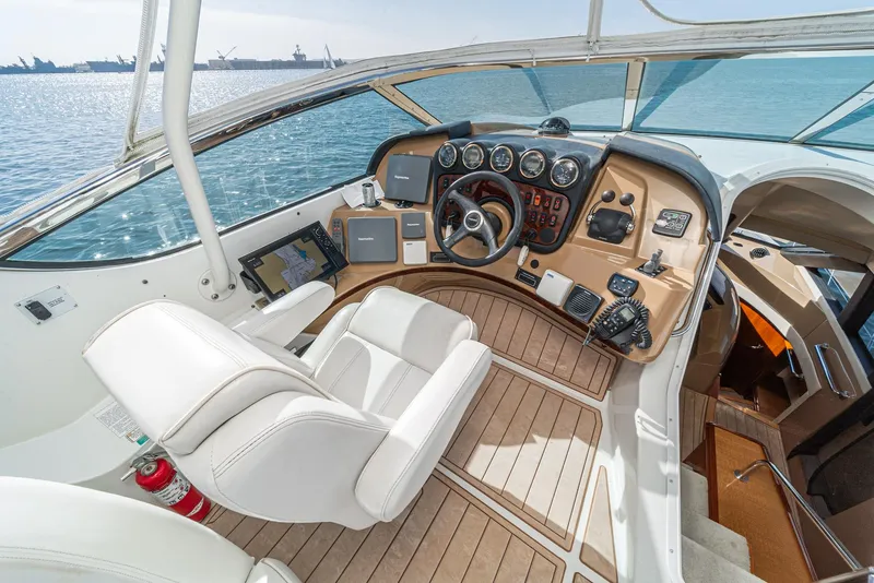 Slide: The Image of 2003 Carver 570 Voyager Pilothouse helm with modern controls and ocean view. - 15