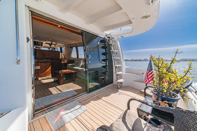 Slide: The Image of Luxurious 2003 Carver 570 Voyager Pilothouse yacht interior with ocean view and elegant decor. - 34