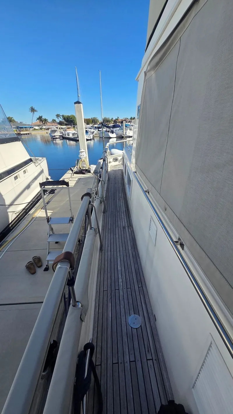 Slide: The Image of Walkway of a 1997 Grand Banks 49 Classic yacht in a marina. - 20
