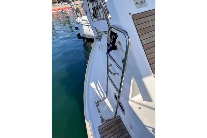 Slide: The Image of 2006 Beneteau 343 sailboat deck with stainless steel ladder and wooden accents. - 10