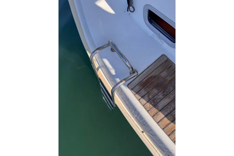 Slide: The Image of Stern view of 2006 Beneteau 343 sailboat with wooden deck and metal ladder. - 11