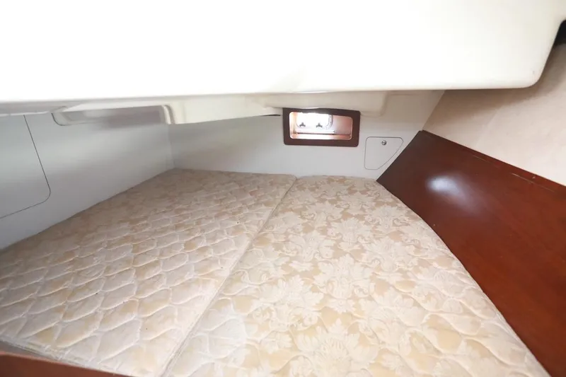 Slide: The Image of Cozy cabin interior of 2006 Beneteau 343 sailboat with mattress and porthole. - 21