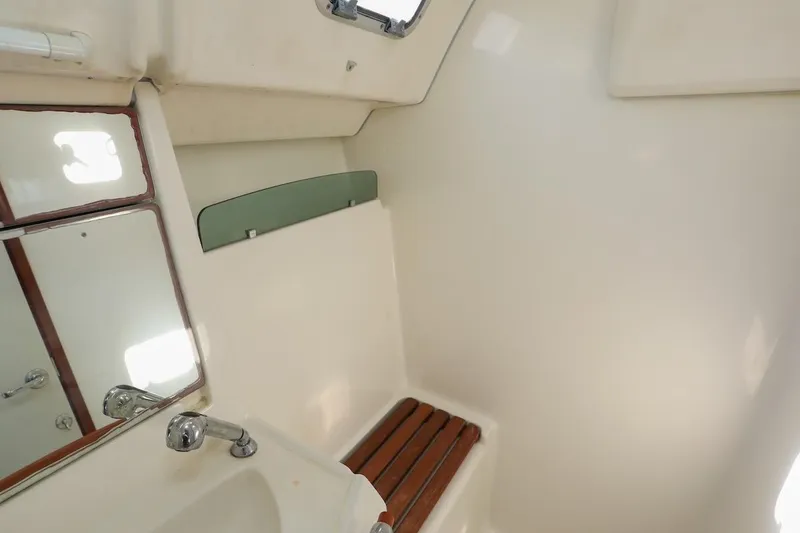 Slide: The Image of Interior of 2006 Beneteau 343 yacht bathroom with sink and wooden seat. - 23