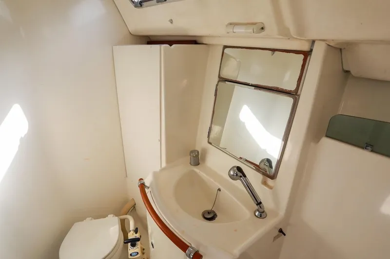Slide: The Image of Bathroom interior of 2006 Beneteau 343 yacht with sink, mirror, and toilet. - 24