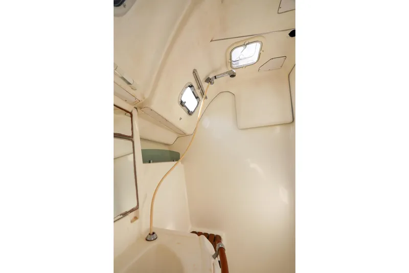 Slide: The Image of Interior of 2006 Beneteau 343 sailboat bathroom with shower and portholes. - 25