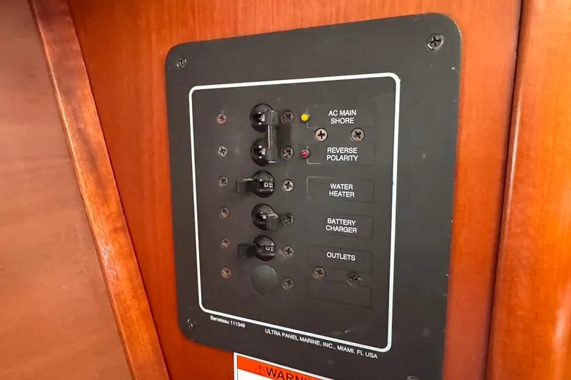 Slide: The Image of Electrical panel on a 2006 Beneteau 343 sailboat, featuring various switches and indicators. - 29