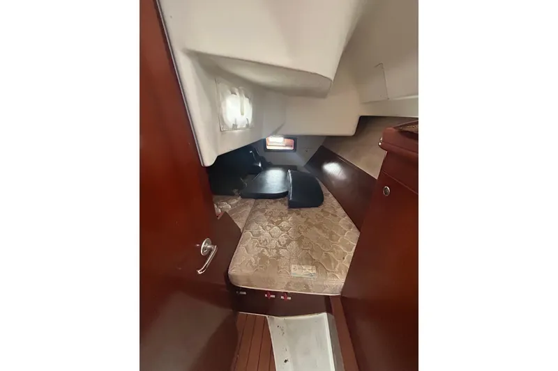 Slide: The Image of 2006 Beneteau 343 cabin interior with wooden finish and cozy sleeping area. - 38