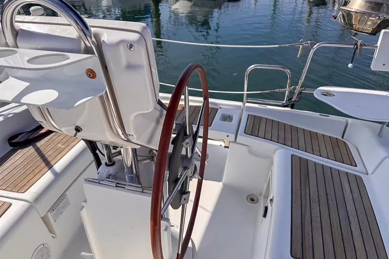 Slide: The Image of Cockpit of 2006 Beneteau 343 sailboat with wooden accents and steering wheel. - 7
