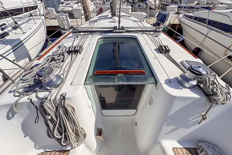 Slide: The Image of 2006 Beneteau 343 sailboat deck with ropes and winches in marina. - 8