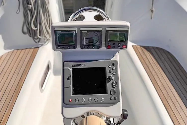 Slide: The Image of Steering console of 2006 Beneteau 343 sailboat with navigation instruments and teak decking. - 9