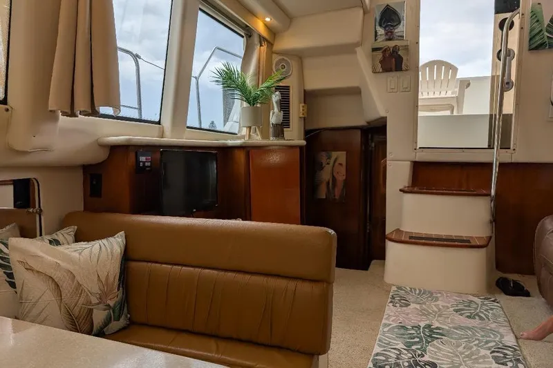 Slide: The Image of Interior of 2003 Carver 356 Motor Yacht with cozy seating and decor. - 19