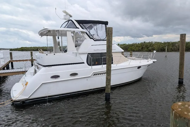 Slide: The Image of 2003 Carver 356 Motor Yacht docked on a cloudy day. - 2