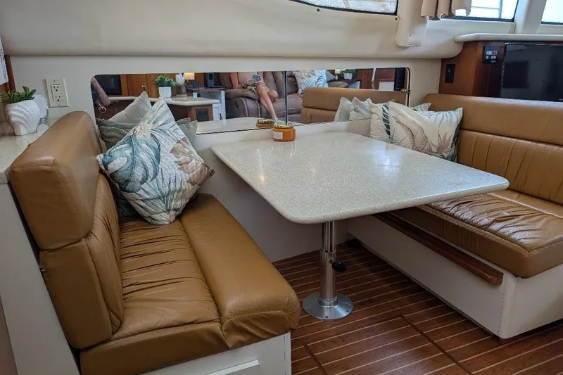 Slide: The Image of Interior of 2003 Carver 356 Motor Yacht with leather seating and dining table. - 23