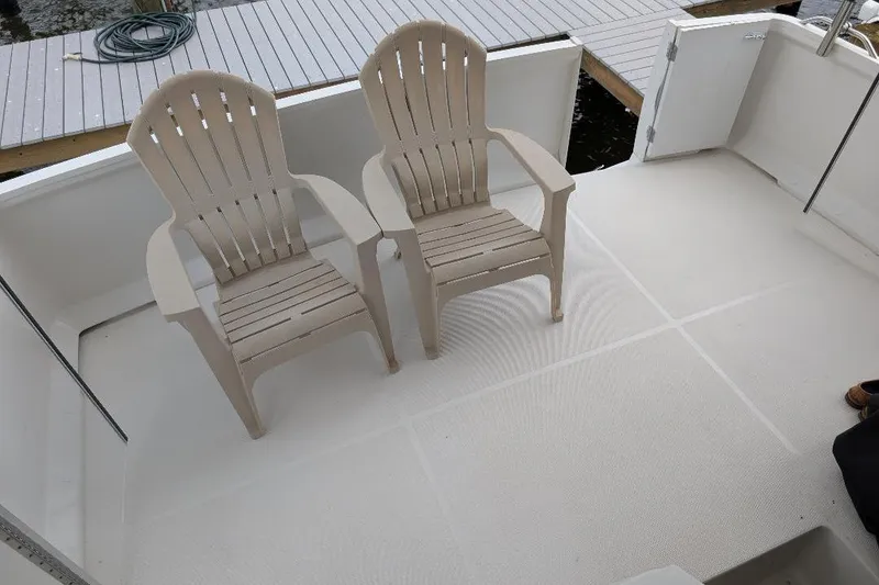 Slide: The Image of Two beige chairs on the deck of a 2003 Carver 356 Motor Yacht. - 12