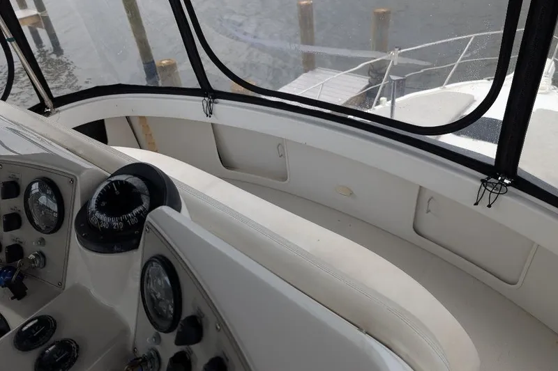 Slide: The Image of 2003 Carver 356 Motor Yacht helm with navigation instruments and seating area. - 17
