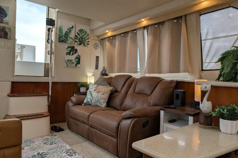 Slide: The Image of Interior of 2003 Carver 356 Motor Yacht with cozy seating and tropical decor. - 18