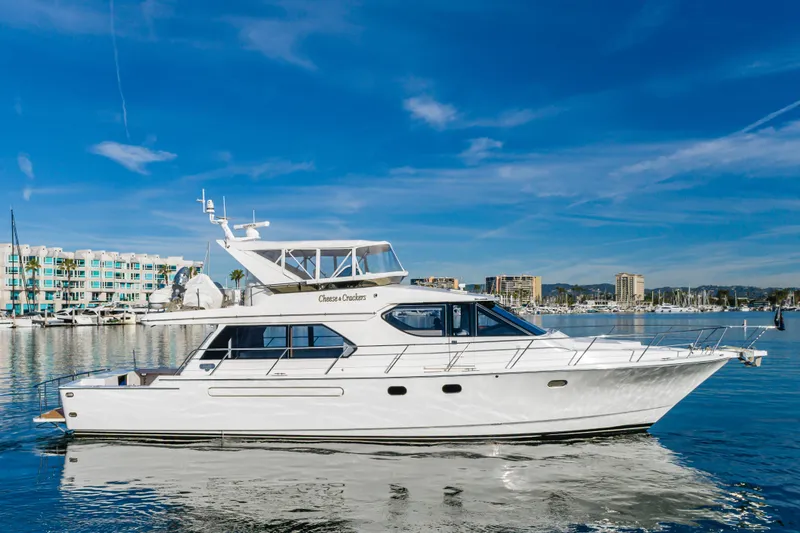 The Image of Luxury 2006 West Bay 64 yacht docked in a scenic marina setting. - 0
