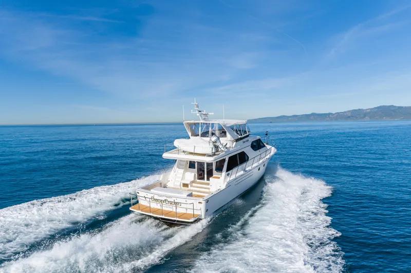 Slide: The Image of Luxury 2006 West Bay 64 yacht cruising on open sea under clear blue sky. - 12