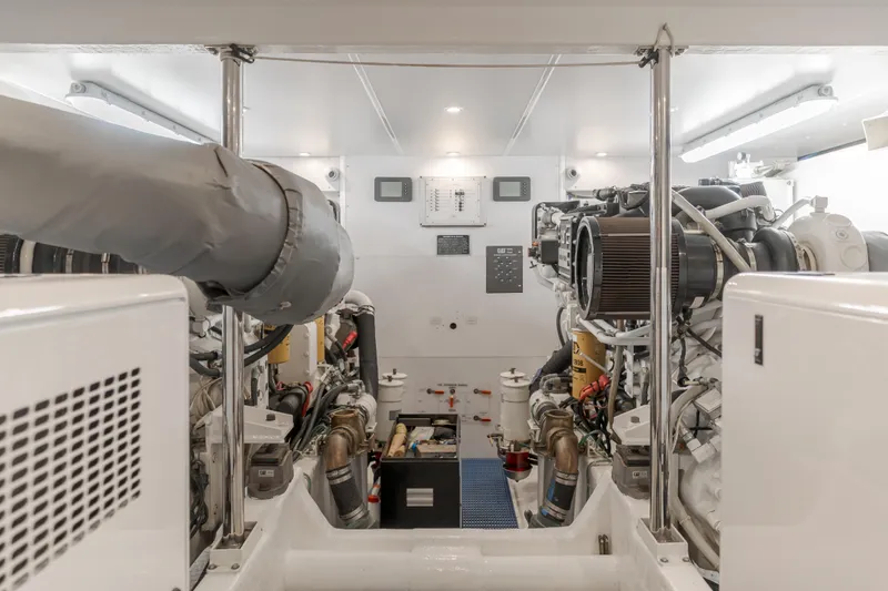 Slide: The Image of Engine room of 2006 West Bay 64 yacht, showcasing dual engines and mechanical systems. - 14