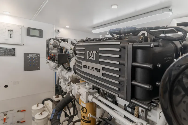 Slide: The Image of Engine room of 2006 West Bay 64 yacht featuring CAT Marine Power engine. - 15