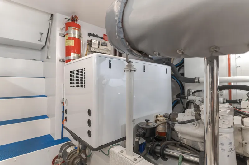 Slide: The Image of Engine room of 2006 West Bay 64 yacht with equipment and fire extinguisher. - 19