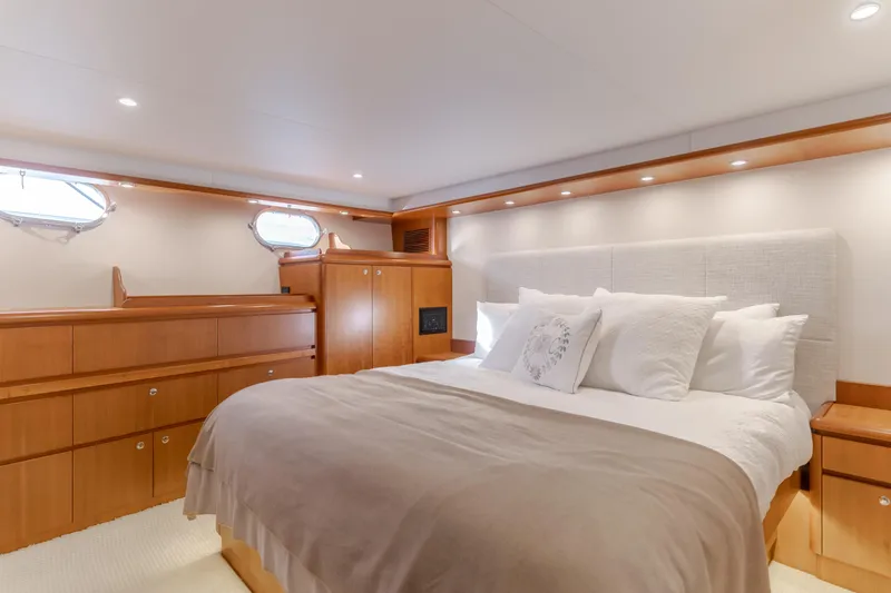 Slide: The Image of Luxurious bedroom interior of 2006 West Bay 64 yacht with elegant wood finishes. - 21