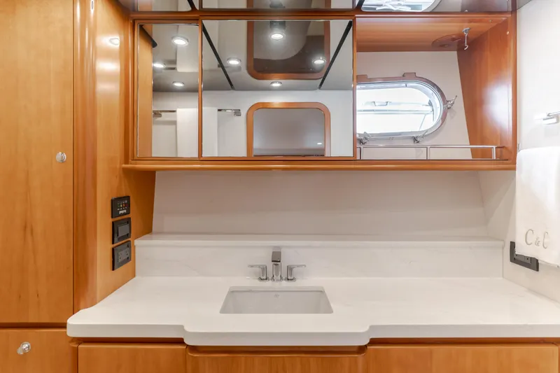 Slide: The Image of Luxurious bathroom in 2006 West Bay 64 yacht with wood cabinetry and modern fixtures. - 24