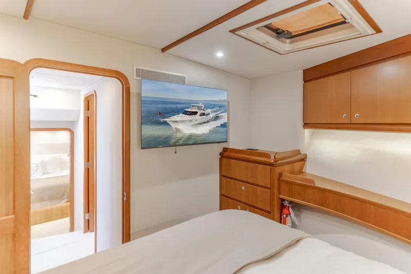 Slide: The Image of Luxurious interior of 2006 West Bay 64 yacht with elegant wood cabinetry and marine artwork. - 29