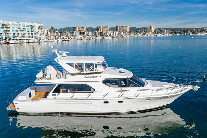 Slide: The Image of Luxury 2006 West Bay 64 yacht docked in a scenic marina setting. - 3