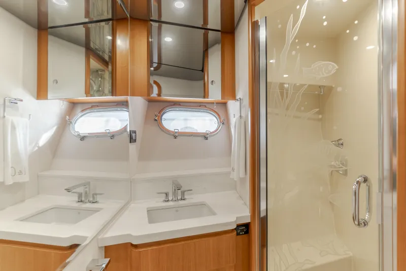 Slide: The Image of Luxurious bathroom in 2006 West Bay 64 yacht with dual sinks and glass shower. - 32