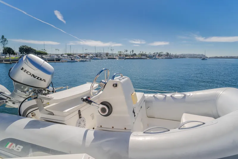 Slide: The Image of Inflatable boat with Honda motor on calm water, West Bay 64, 2006 model. - 34