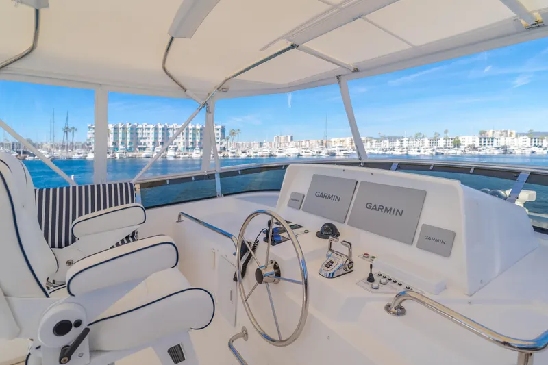Slide: The Image of Luxurious 2006 West Bay 64 yacht helm with Garmin navigation, overlooking marina. - 38