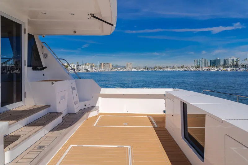 Slide: The Image of Luxurious 2006 West Bay 64 yacht deck with scenic marina view. - 42