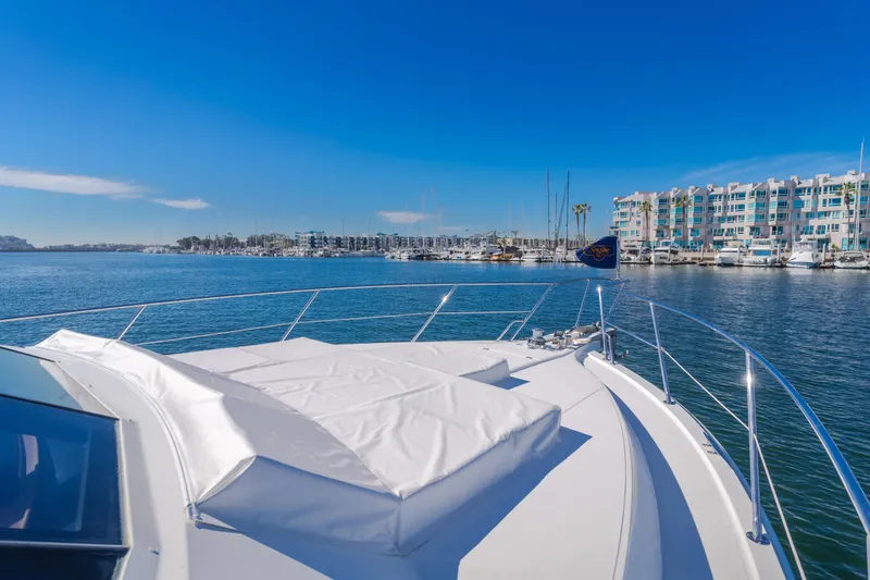 Slide: The Image of Luxury West Bay 64 yacht from 2006 docked in a scenic marina. - 43