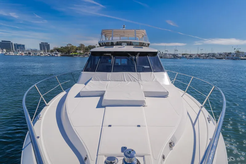 Slide: The Image of 2006 West Bay 64 yacht on calm water with marina backdrop. - 44