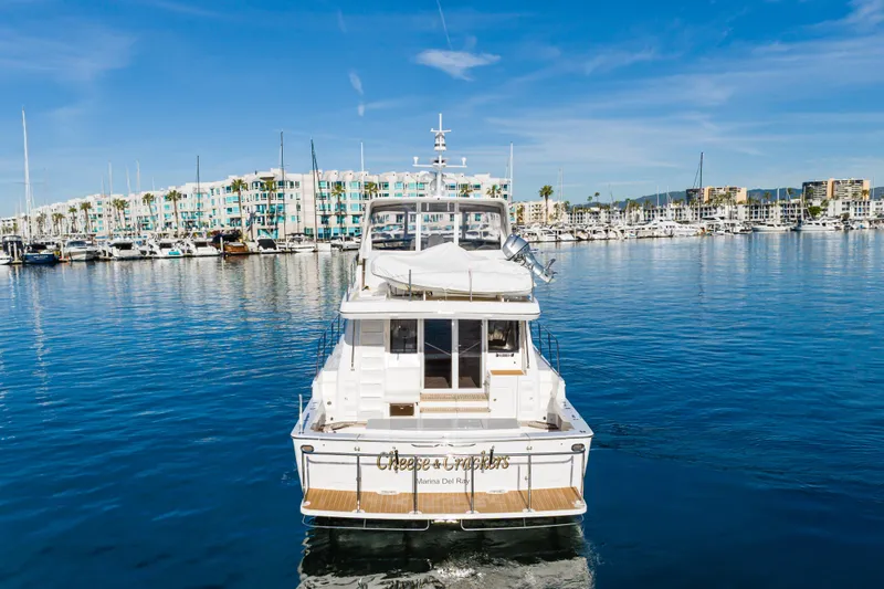 Slide: The Image of 2006 West Bay 64 yacht in marina, clear blue sky, waterfront buildings. - 5