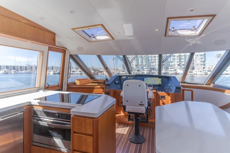 Slide: The Image of Luxurious 2006 West Bay 64 yacht interior with modern helm and panoramic marina views. - 50