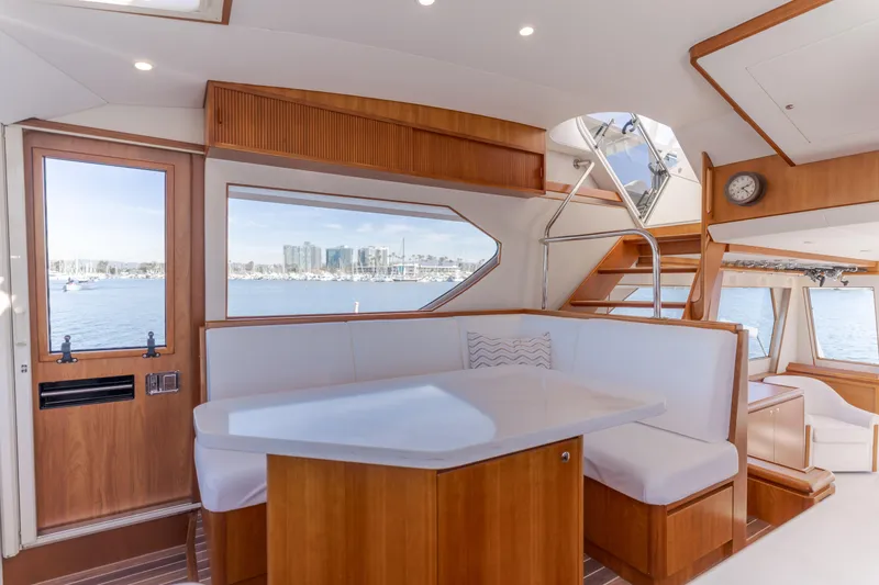 Slide: The Image of Luxurious interior of 2006 West Bay 64 yacht with elegant wood and white seating. - 52