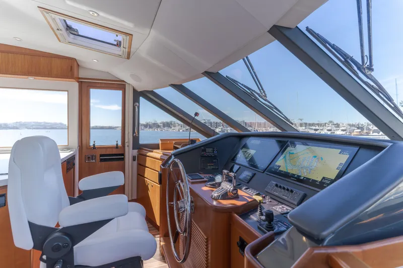 Slide: The Image of Interior helm of 2006 West Bay 64 yacht with navigation screens and steering wheel. - 54