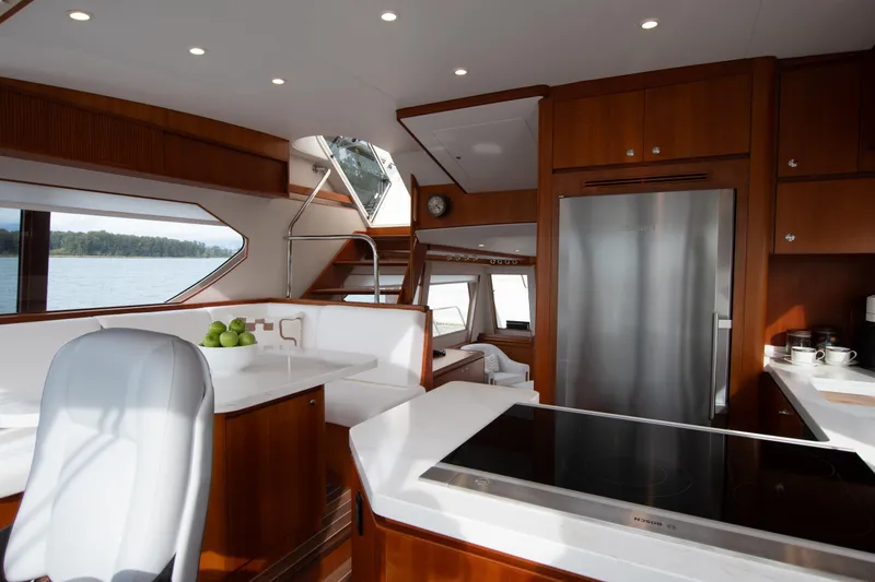 Slide: The Image of Luxurious 2006 West Bay 64 yacht interior with modern kitchen and scenic window views. - 55