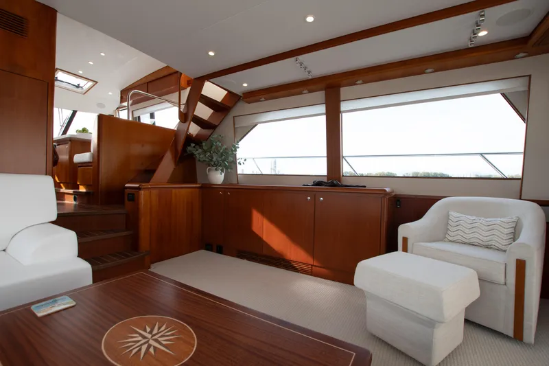 Slide: The Image of Luxurious interior of 2006 West Bay 64 yacht with elegant wood finishes and modern seating. - 58