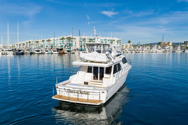 Slide: The Image of Luxury 2006 West Bay 64 yacht docked in a scenic marina setting. - 6