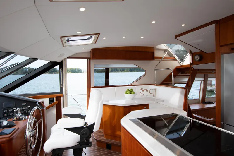 Slide: The Image of Luxurious interior of 2006 West Bay 64 yacht with modern kitchen and helm. - 60