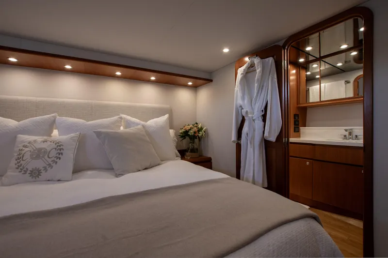 Slide: The Image of Luxurious bedroom interior of 2006 West Bay 64 yacht with elegant bedding and robe. - 62