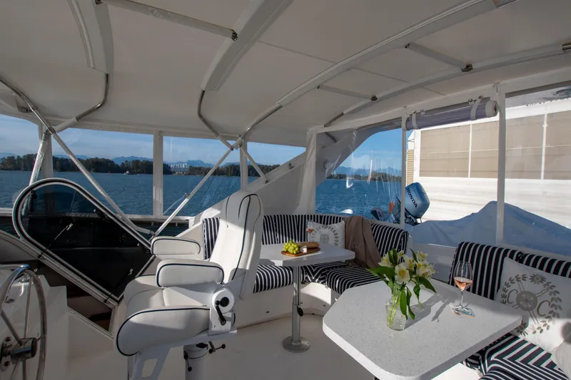 Slide: The Image of Luxurious 2006 West Bay 64 yacht interior with elegant seating and scenic ocean view. - 65