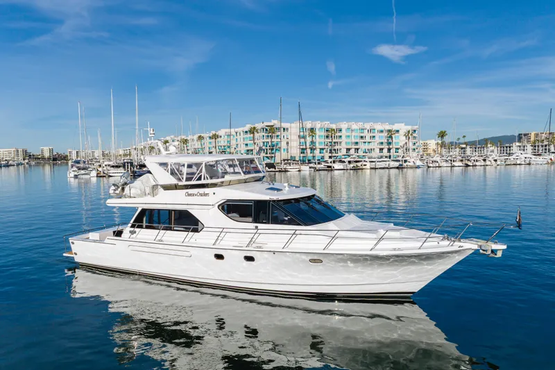 Slide: The Image of Luxury 2006 West Bay 64 yacht docked in a serene marina setting. - 7
