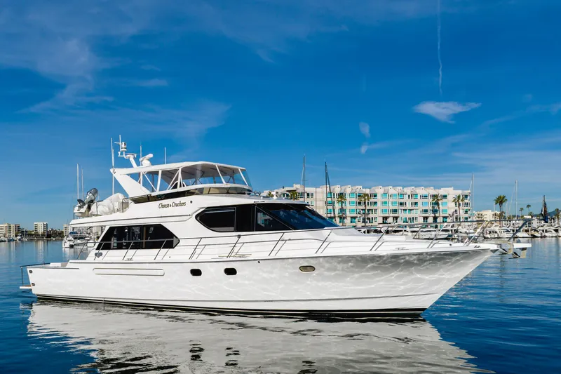 Slide: The Image of Luxury 2006 West Bay 64 yacht docked in a marina under clear blue skies. - 8