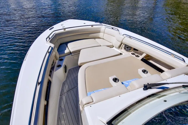 Slide: The Image of 2019 Boston Whaler 350 Realm boat interior with cushioned seating and cup holders. - 12